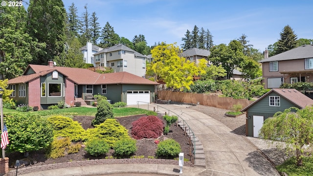 view of front of home featuring a garage, concrete driveway, and a residential view