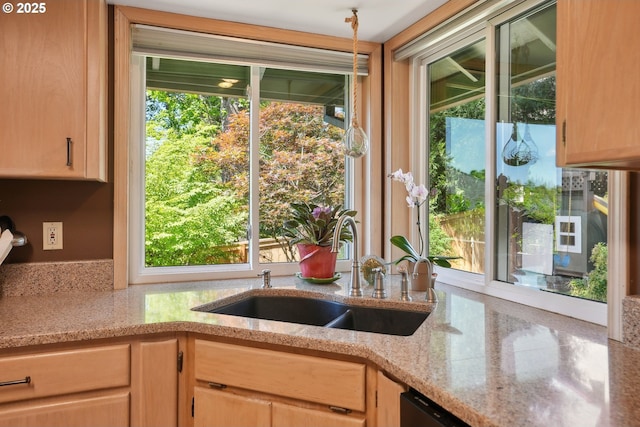 kitchen featuring a sink, light brown cabinetry, and plenty of natural light