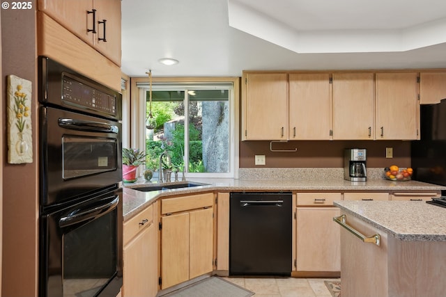 kitchen featuring light brown cabinets, black appliances, a sink, light countertops, and recessed lighting