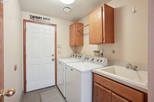 clothes washing area with cabinet space and washing machine and clothes dryer