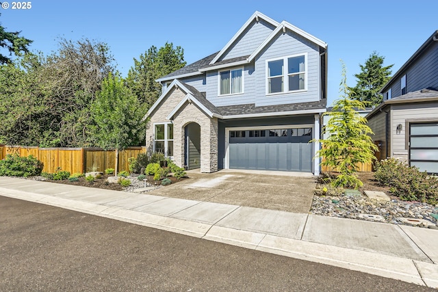 7414 SW 80th Ter, Portland, OR 97223 - craftsman-style home featuring an attached garage, driveway, roof with shingles, and stone siding