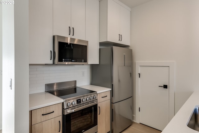 3727 N Michigan Ave, Portland, OR 97227 - kitchen with stainless steel appliances, light countertops, backsplash, and modern cabinets