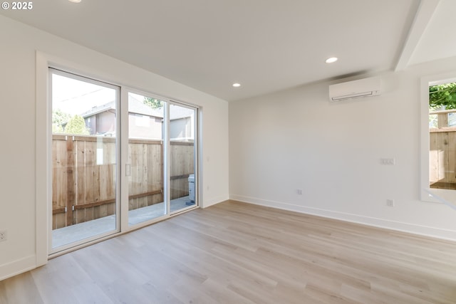 3727 N Michigan Ave, Portland, OR 97227 - spare room featuring an AC wall unit, light wood-style flooring, and recessed lighting