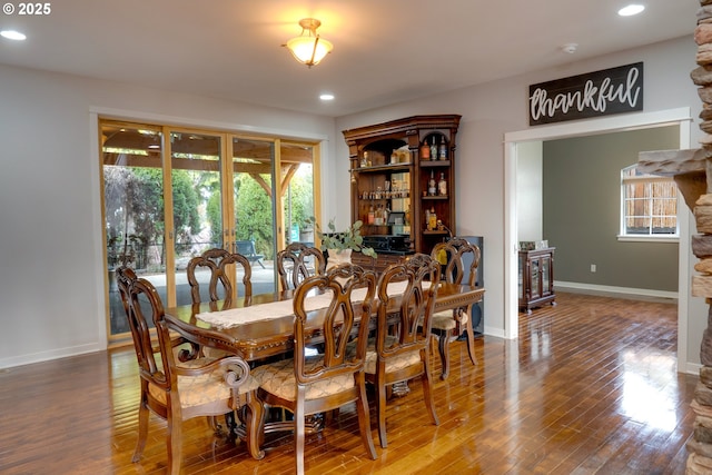 dining space with hardwood / wood-style flooring