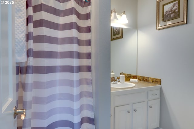 bathroom featuring vanity and curtained shower