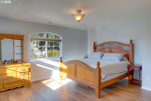 bedroom with hardwood / wood-style flooring