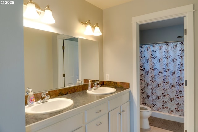 bathroom with a shower with curtain, vanity, tile patterned flooring, and toilet