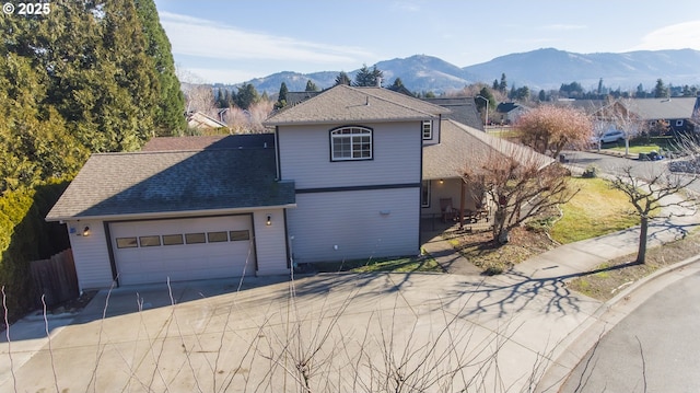 view of front of home with a garage and a mountain view