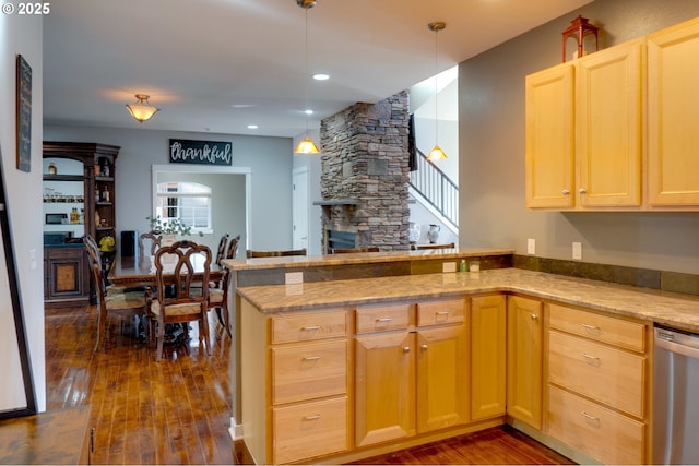 kitchen featuring dark wood-type flooring, decorative light fixtures, kitchen peninsula, and dishwasher