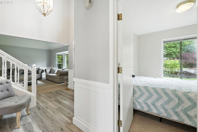 18135 SW Hart Dr, Beaverton, OR 97007 - entryway featuring light wood finished floors, a towering ceiling, a chandelier, and stairway