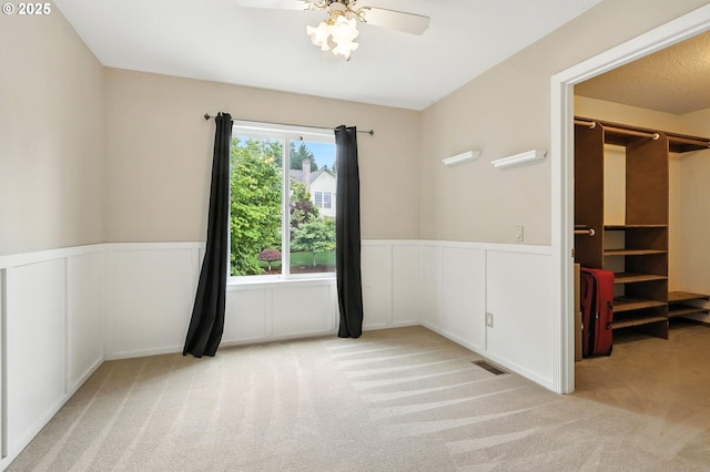 18135 SW Hart Dr, Beaverton, OR 97007 - unfurnished bedroom with carpet flooring, a wainscoted wall, a decorative wall, and ceiling fan