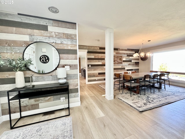 1082 E Highland Ave, Hermiston, OR 97838 - dining area featuring wooden walls, wood finished floors, ornate columns, and a chandelier