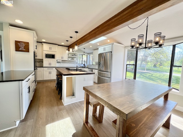 1082 E Highland Ave, Hermiston, OR 97838 - kitchen featuring appliances with stainless steel finishes, a kitchen island with sink, recessed lighting, light wood-style flooring, and a chandelier