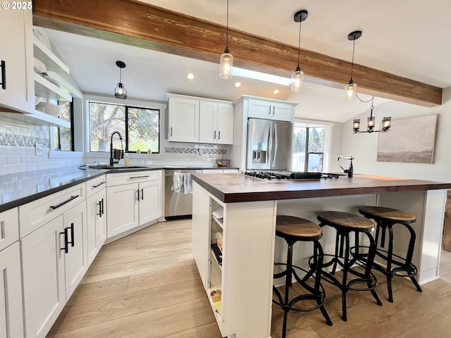 1082 E Highland Ave, Hermiston, OR 97838 - kitchen featuring appliances with stainless steel finishes, butcher block countertops, a sink, recessed lighting, and beam ceiling