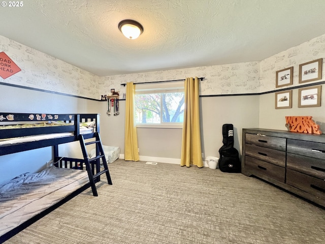 1082 E Highland Ave, Hermiston, OR 97838 - carpeted bedroom with wallpapered walls, baseboards, and a textured ceiling