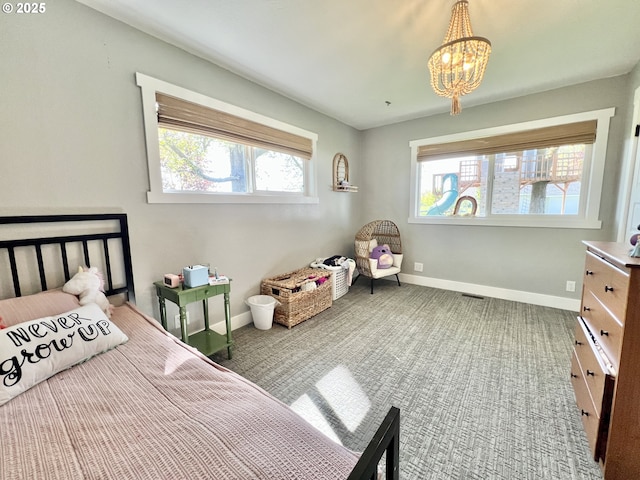 1082 E Highland Ave, Hermiston, OR 97838 - bedroom with a chandelier, baseboards, and carpet