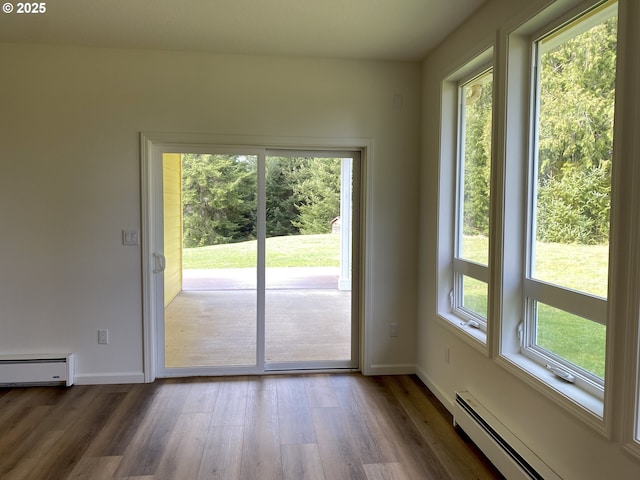 doorway featuring dark wood-style flooring, a baseboard radiator, and baseboards