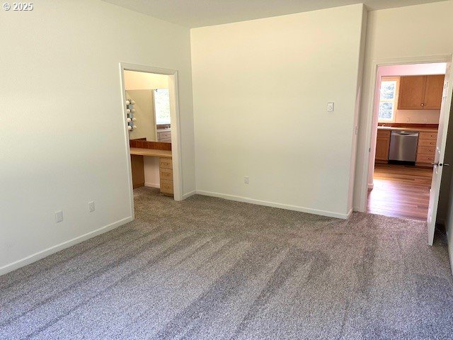 unfurnished bedroom with carpet flooring and baseboards