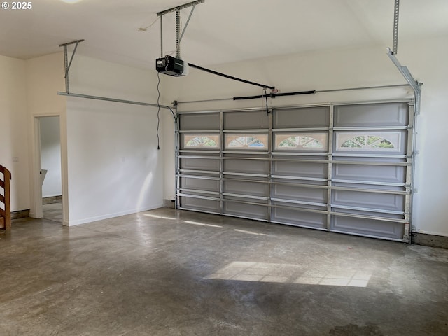 garage with baseboards and a garage door opener