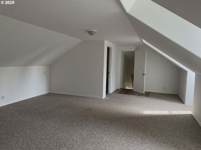 bonus room featuring carpet flooring, vaulted ceiling, and baseboards