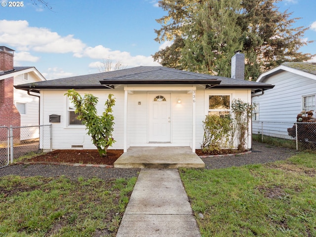 bungalow-style home featuring a front yard