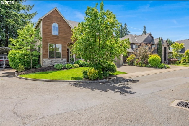 8614 SW Logan Ln, Tualatin, OR 97062 - view of front of property with stone siding, driveway, and a front lawn