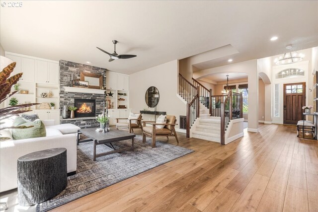 8614 SW Logan Ln, Tualatin, OR 97062 - living room featuring arched walkways, stairs, a chandelier, light wood finished floors, and recessed lighting