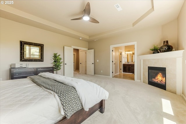 8614 SW Logan Ln, Tualatin, OR 97062 - bedroom with carpet flooring, a tile fireplace, ceiling fan, baseboards, and ensuite bath