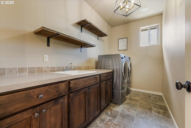 8614 SW Logan Ln, Tualatin, OR 97062 - washroom with separate washer and dryer, baseboards, dark stone finish flooring, and cabinet space