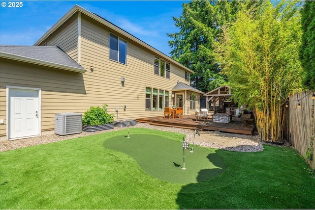 8614 SW Logan Ln, Tualatin, OR 97062 - back of house with a gazebo, a wooden deck, an area to practice putting, central AC, and roof with shingles