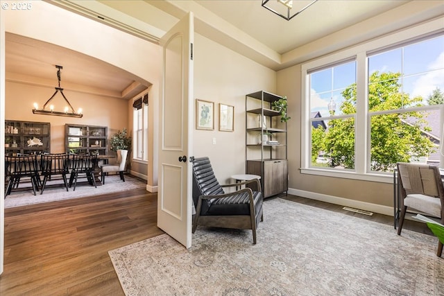 8614 SW Logan Ln, Tualatin, OR 97062 - sitting room featuring a chandelier, wood finished floors, a raised ceiling, and baseboards