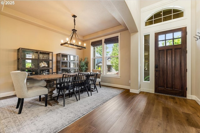 8614 SW Logan Ln, Tualatin, OR 97062 - dining space with a chandelier, baseboards, wood finished floors, and a raised ceiling