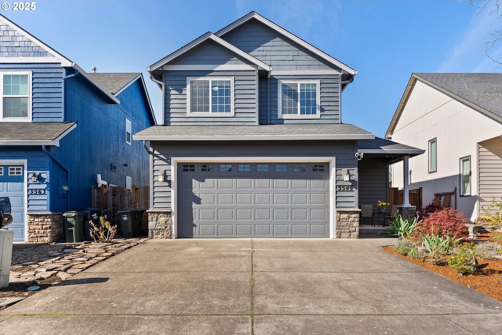 5549 Lancelot Way, Eugene, OR 97402 - view of front of house with stone siding, driveway, and a garage