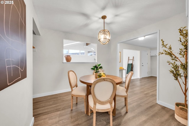 dining room featuring baseboards and wood finished floors