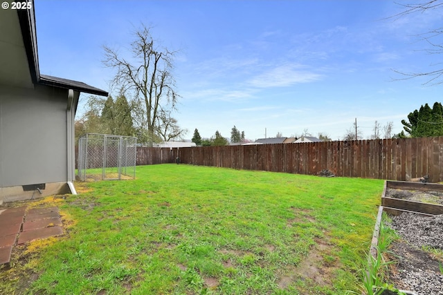 view of yard with a fenced backyard and a garden