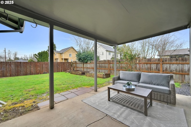 view of patio featuring outdoor lounge area, a fenced backyard, and a garden