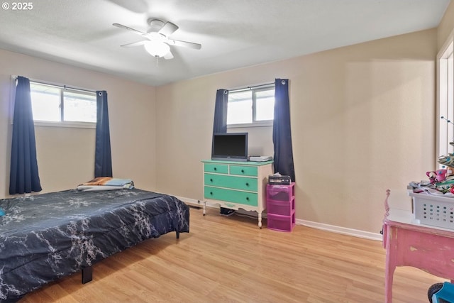 3574 SE Jefferson Marion Rd, Jefferson, OR 97352 - bedroom with light wood-type flooring, multiple windows, baseboards, and a ceiling fan