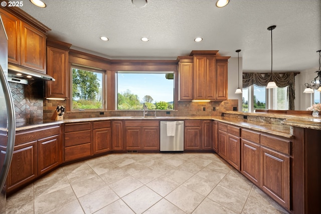 kitchen with stainless steel dishwasher, a sink, a textured ceiling, and decorative backsplash