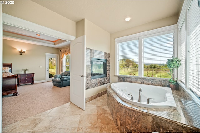 full bath featuring crown molding, baseboards, plenty of natural light, and a whirlpool tub