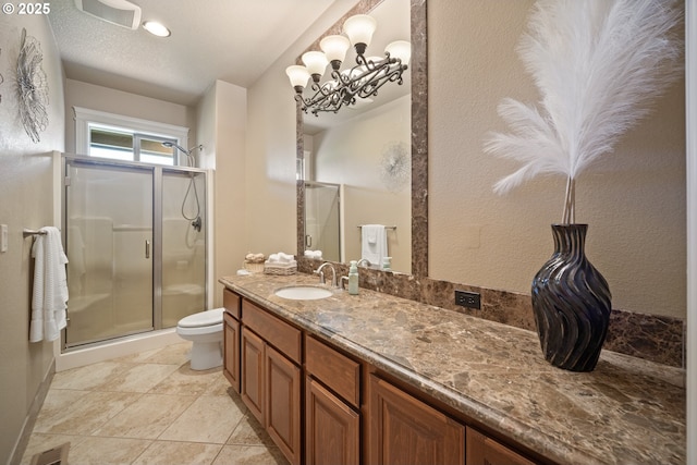 full bath featuring vanity, toilet, visible vents, and a stall shower