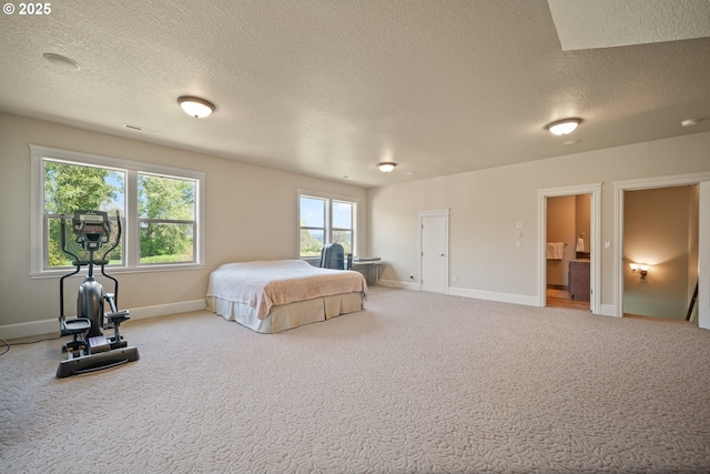 carpeted bedroom with a textured ceiling, visible vents, and baseboards