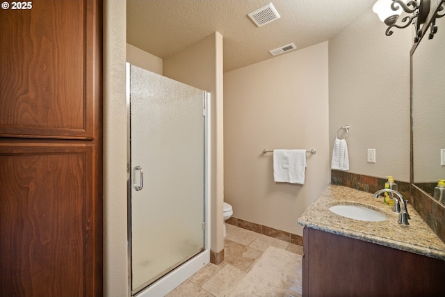 bathroom with toilet, visible vents, a shower stall, and vanity