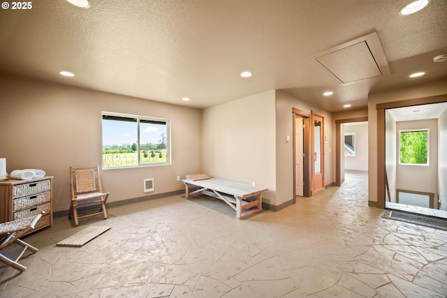 bedroom featuring recessed lighting, attic access, and multiple windows