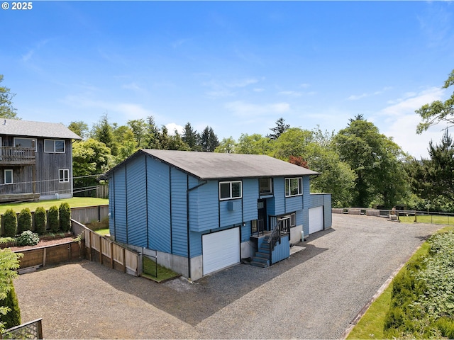 35208 Orchard Ln, Astoria, OR 97103 - view of front of house featuring a detached garage and view of wooded area