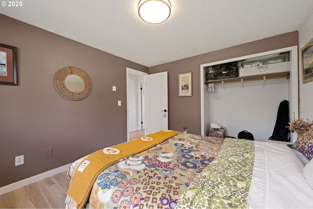 35208 Orchard Ln, Astoria, OR 97103 - bedroom with wood finished floors, a closet, and baseboards
