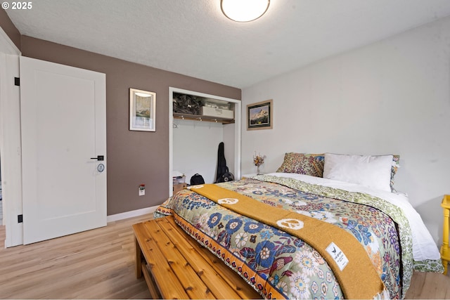 35208 Orchard Ln, Astoria, OR 97103 - bedroom with light wood-style floors, a closet, and baseboards