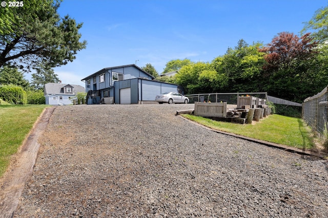 35208 Orchard Ln, Astoria, OR 97103 - view of front facade featuring gravel driveway and an attached garage