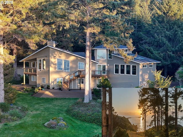 view of front of property with a yard and a balcony