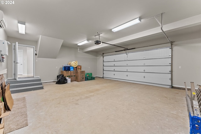 garage featuring a garage door opener and a wall mounted air conditioner