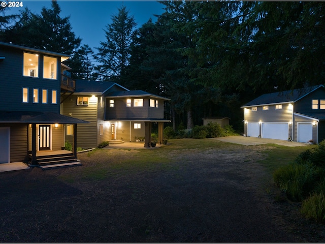 exterior space with a garage, an outbuilding, and covered porch